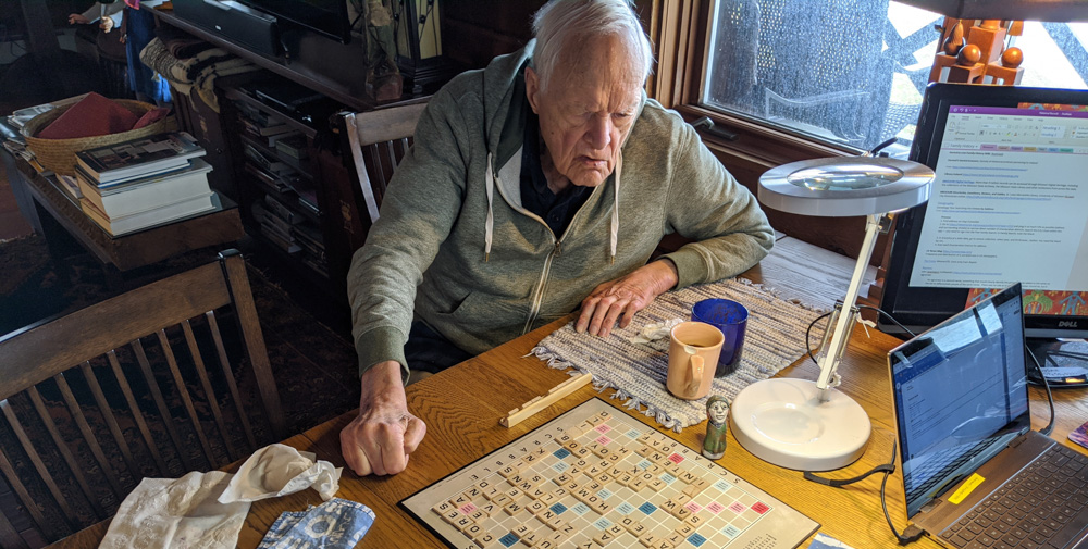 Jim wearing his hoodie, playing Scrabble